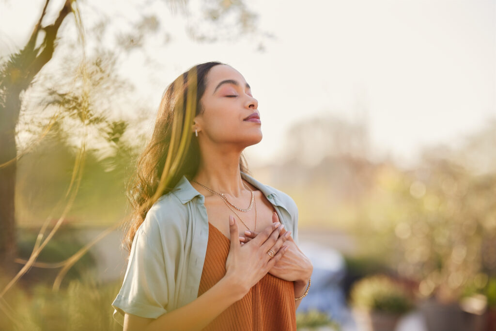 Woman breathing deeply outside