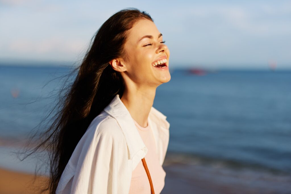 Woman smiling by the ocean